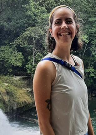 Celia Larson poses in front of a waterfall