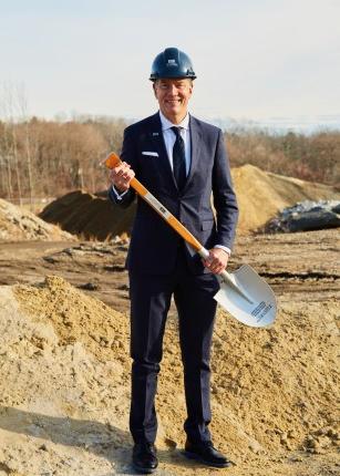 UNE President James Herbert poses with a shovel