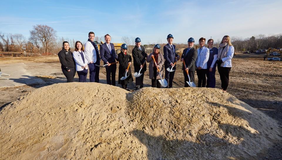 UNE leadership dig into the earth at the groundbreaking ceremony for the Harold and Bibby Center for Health Sciences on Tuesday, Nov. 29, 2022