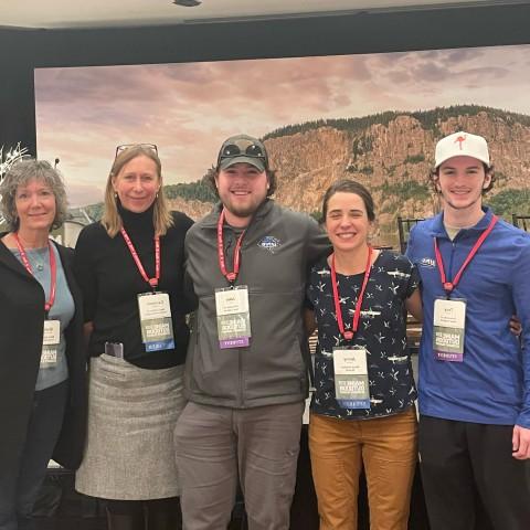 UNE students Troy Fowler and Jake Tobin pose with representatives from Maine's outdoor economy at the Maine Outdoor Economy Summit in Rockland